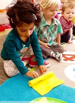Montessori art area where students are expressing creativity through open-ended painting activities.