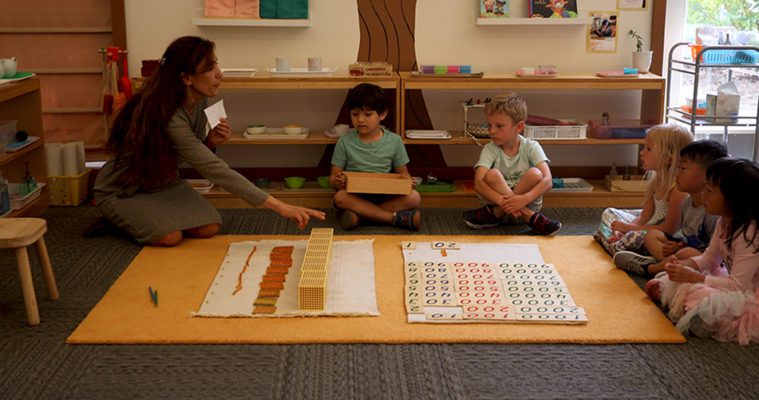 A quiet moment in a Montessori classroom with children working on independent tasks.